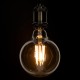 GloboStar® 99044 Λάμπα LED Long Filament E27 G125 Γλόμπος 12W 1080lm 360° AC 220-240V IP20 Φ12.5 x Υ18cm Ultra Θερμό Λευκό 2200K με Μελί Γυαλί - Dimmable - 3 Years Warranty